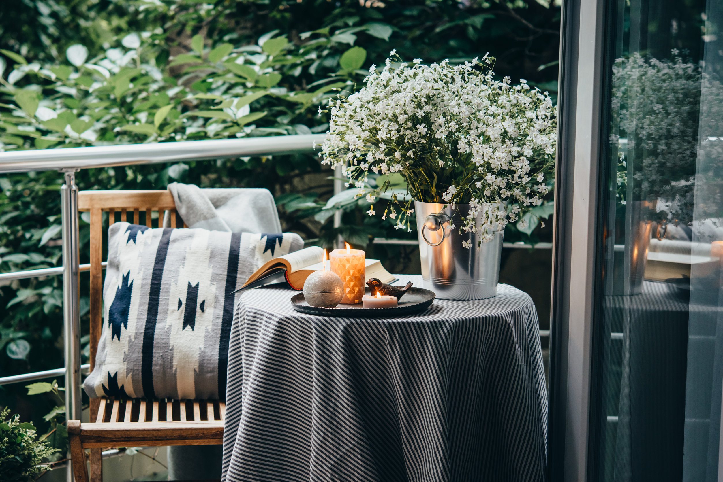 Balcony with throw pillow and candles in spring.